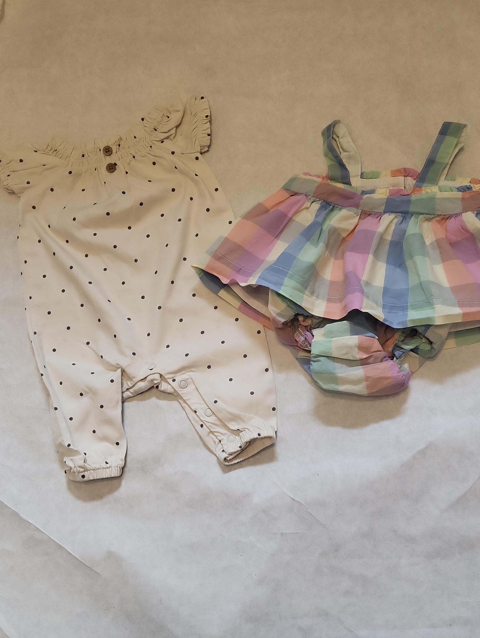 Set Includes Two Infant Outfits. Cream Cotton Romper & Two Piece Plaid Sundress.